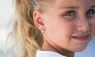 girl with amalia star huggie earrings