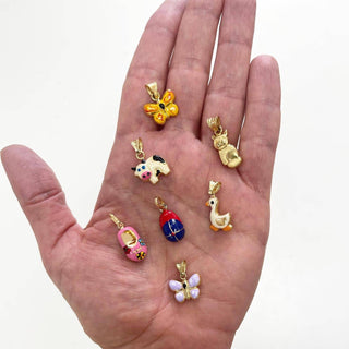 hand showing many Amalia animals and shoe pendants