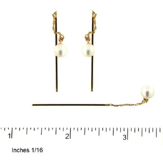 18k solid yellow gold pearl thread earrings next to ruler