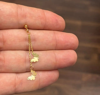 18K Solid Yellow Gold Long Dangle Butterfly Earrings in a hand