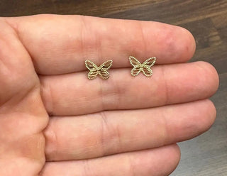 18K Solid Yellow Gold open Butterfly Post Earrings in the hand
